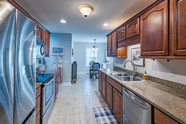 kitchen with a sink, recessed lighting, stainless steel appliances, baseboards, and a chandelier