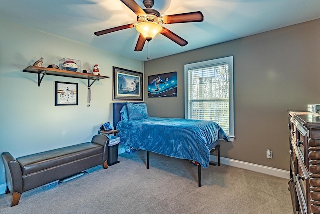 carpeted bedroom with baseboards and a ceiling fan