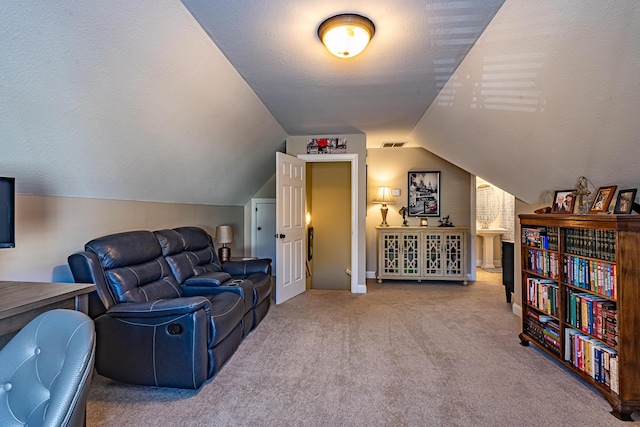 interior space featuring visible vents, a textured ceiling, lofted ceiling, and carpet floors