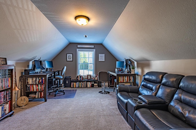 home office featuring vaulted ceiling, carpet, and a textured ceiling