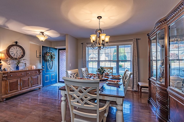 dining area with an inviting chandelier and wood finished floors