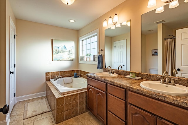 full bathroom with visible vents, toilet, a jetted tub, and a sink