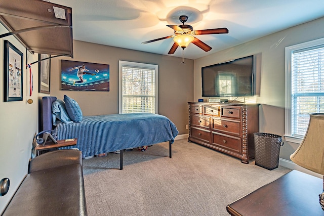 bedroom with carpet flooring, baseboards, and ceiling fan