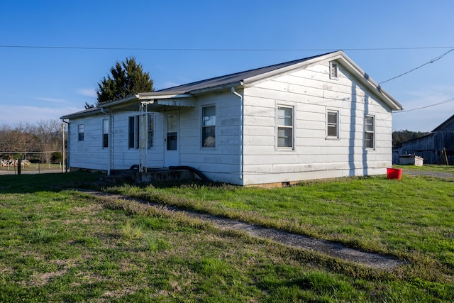 view of property exterior featuring a lawn