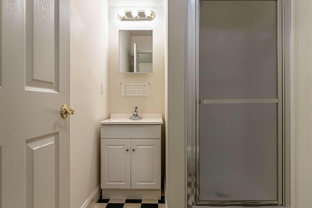 bathroom with vanity and a shower with shower door