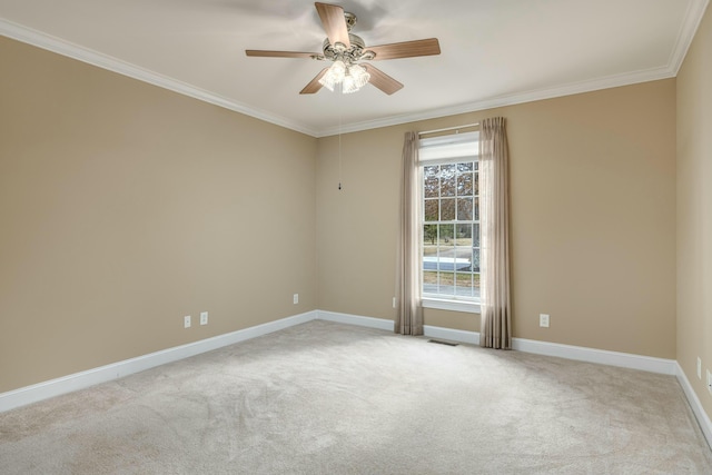 unfurnished room featuring light colored carpet, ceiling fan, and crown molding