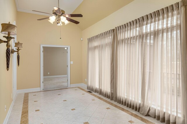 tiled spare room featuring vaulted ceiling and ceiling fan