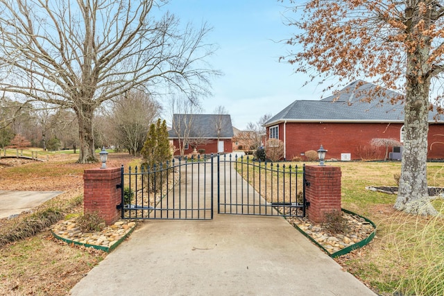 view of gate featuring a yard