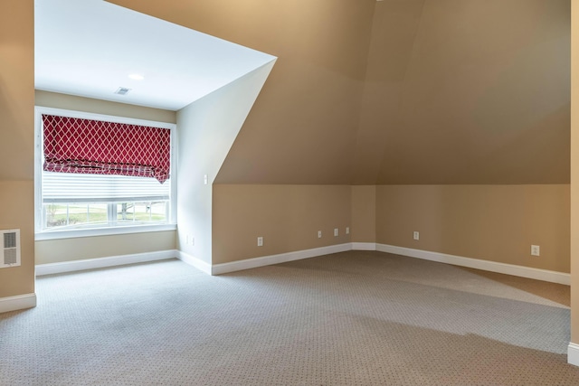 bonus room with carpet floors and lofted ceiling