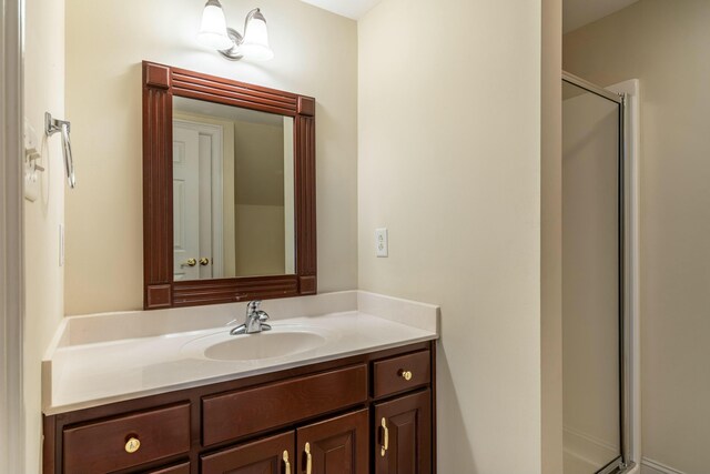 bathroom featuring vanity and a shower with shower door