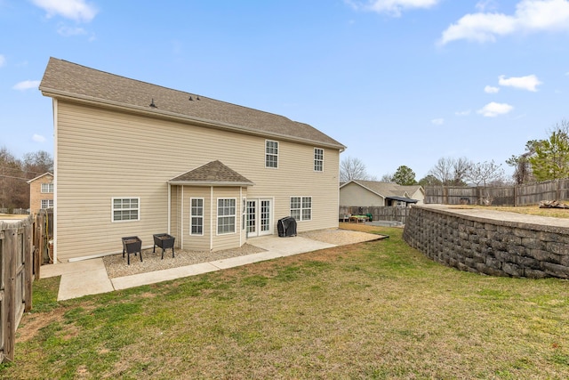 rear view of property with a yard and a patio area