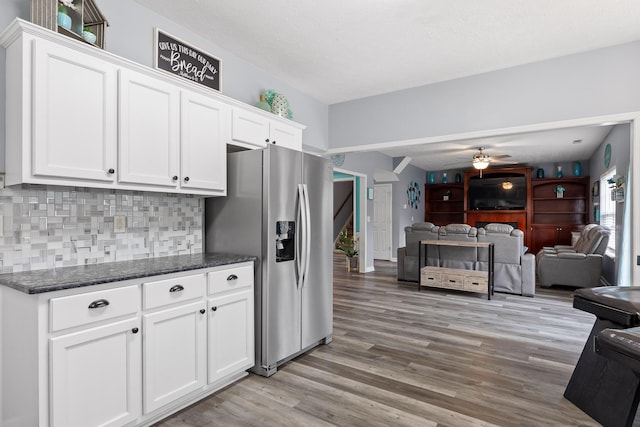 kitchen featuring tasteful backsplash, white cabinetry, ceiling fan, stainless steel refrigerator with ice dispenser, and light wood-type flooring