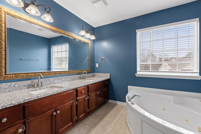 bathroom featuring tile patterned floors, vanity, and a tub