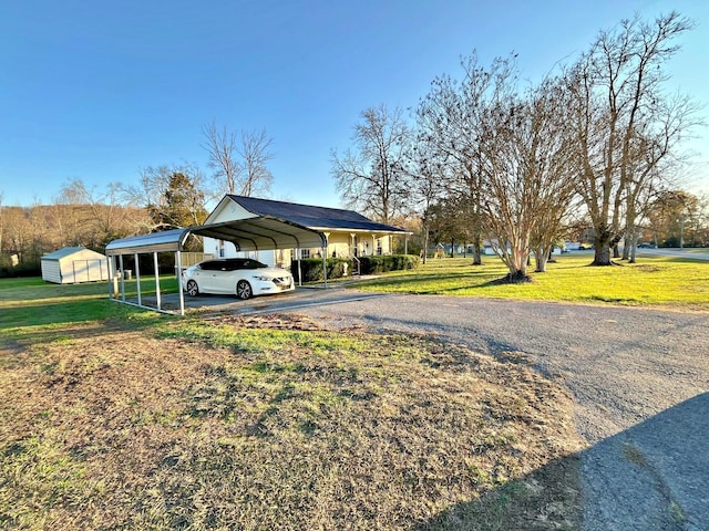 exterior space with a carport and a lawn