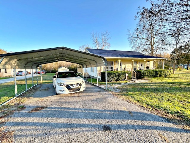 view of vehicle parking featuring a yard and a carport