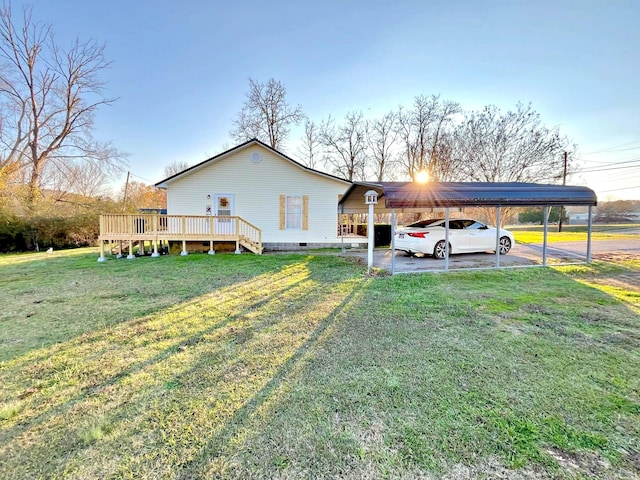 view of side of home featuring a carport, a wooden deck, and a lawn