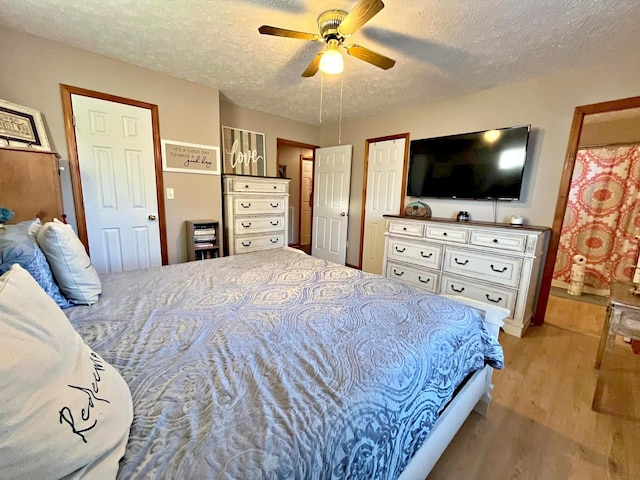 bedroom featuring ceiling fan, a textured ceiling, and light hardwood / wood-style flooring