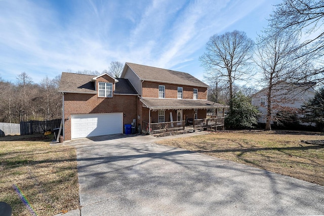 view of front of home with a porch, a garage, and a front lawn