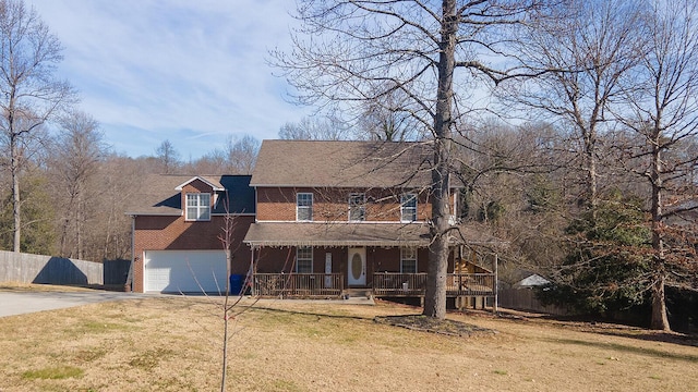 view of front facade featuring a garage, covered porch, and a front lawn