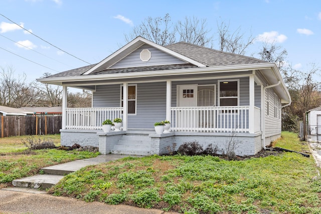 bungalow-style house with covered porch and a front yard