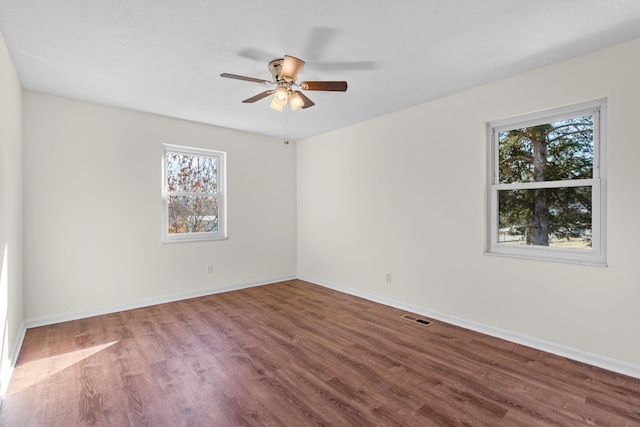 spare room with hardwood / wood-style flooring and ceiling fan