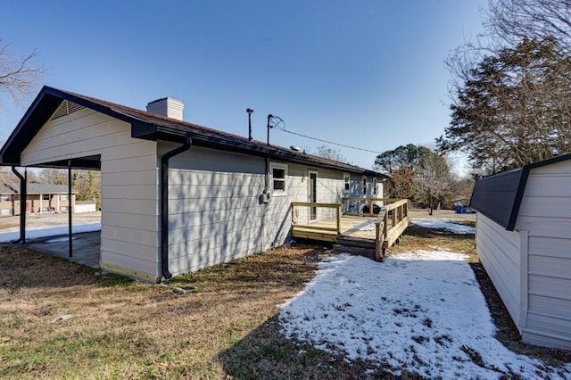 rear view of property featuring a wooden deck