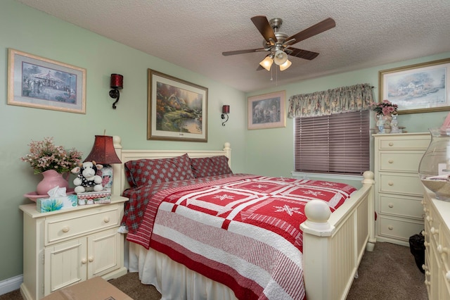 carpeted bedroom featuring ceiling fan and a textured ceiling