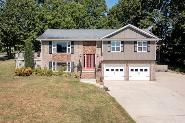 split foyer home featuring a front lawn and a garage