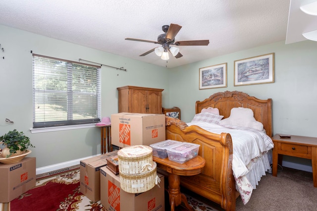 carpeted bedroom with ceiling fan and a textured ceiling