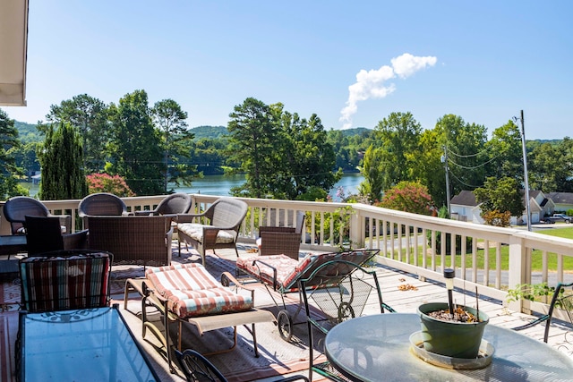 wooden terrace featuring a water view