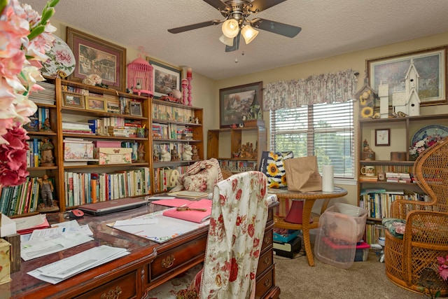 home office featuring a textured ceiling, carpet floors, and ceiling fan