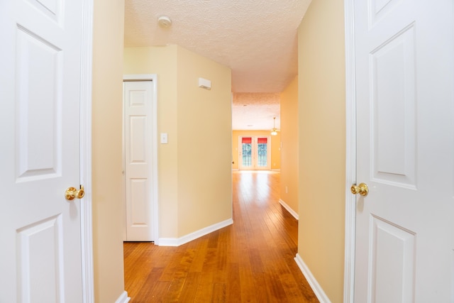 7826 Stone Garden Way, Powell, TN 37849 - hall with wood finished floors, a textured ceiling, and baseboards