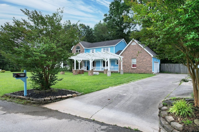 271 Hidden Oaks Trl NE, Cleveland, TN 37312 - view of front facade featuring a pergola, concrete driveway, covered porch, and brick siding