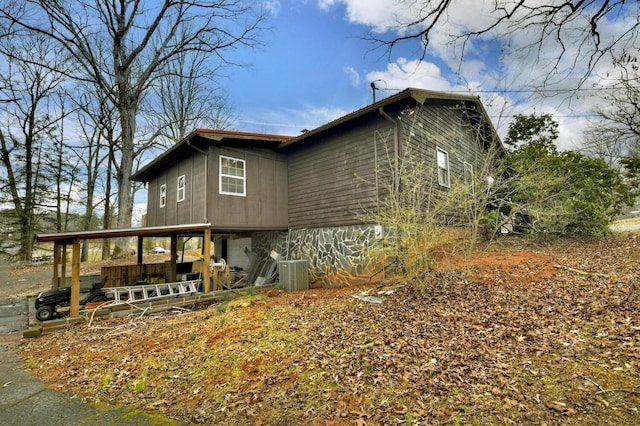 back of property featuring central air condition unit