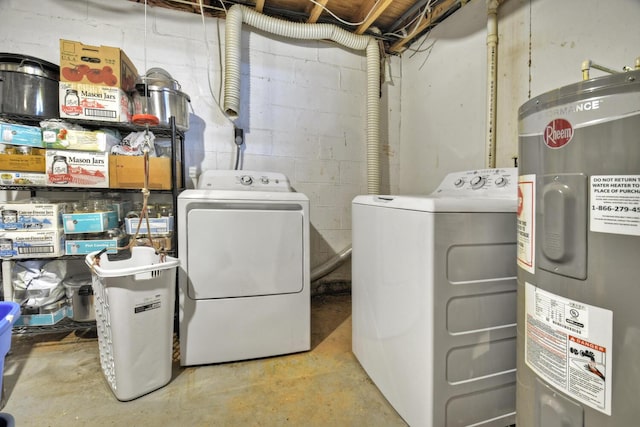 laundry room featuring electric water heater, laundry area, and washer and clothes dryer