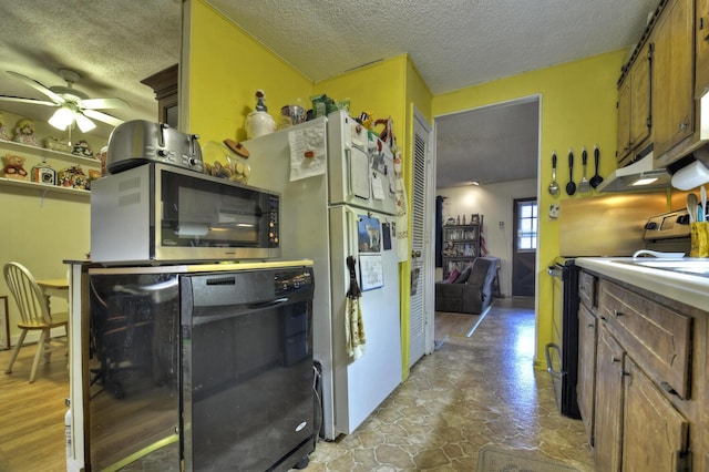 kitchen with a textured ceiling, ceiling fan, stainless steel microwave, black range with electric stovetop, and brown cabinets