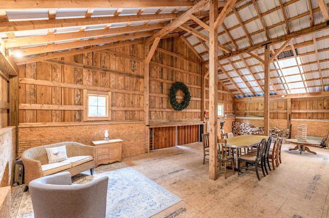 dining space with high vaulted ceiling