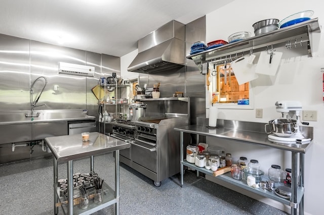 kitchen featuring stainless steel counters, high end range, exhaust hood, and a wall mounted air conditioner