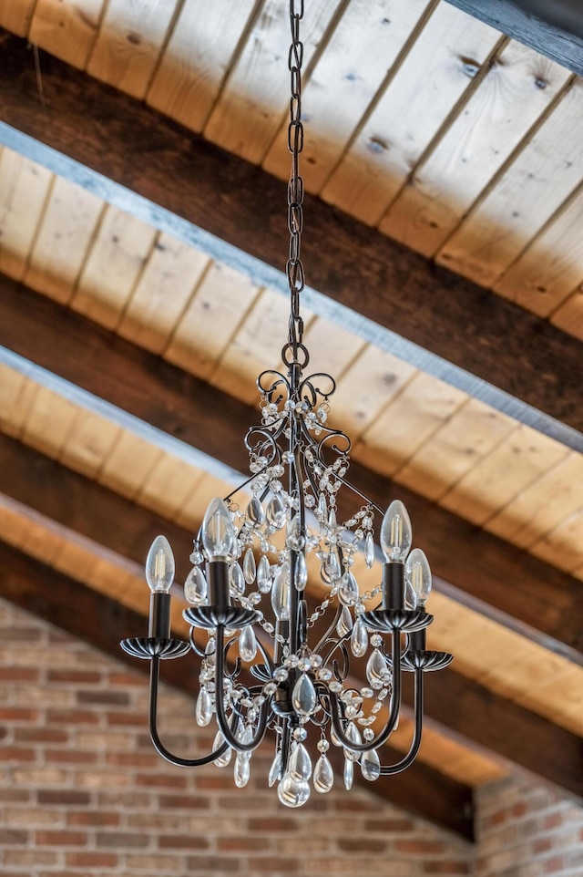 details featuring beam ceiling and a notable chandelier