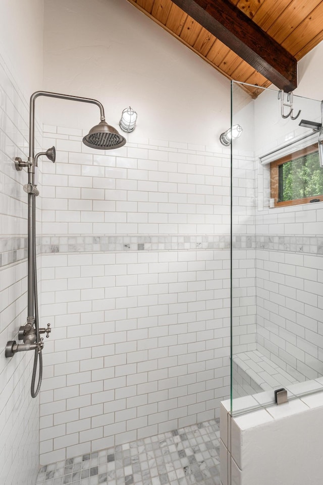 bathroom with beamed ceiling, wooden ceiling, and tiled shower