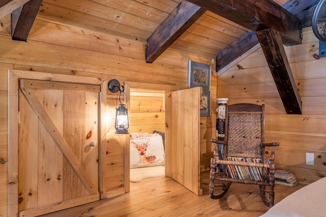 bedroom with vaulted ceiling with beams, wood walls, wood ceiling, and hardwood / wood-style flooring