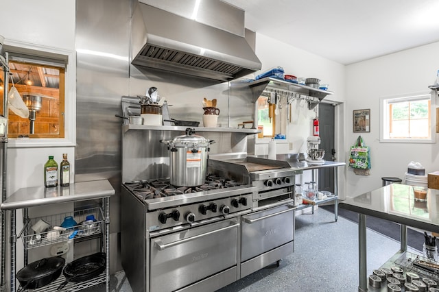 kitchen featuring stainless steel range and range hood