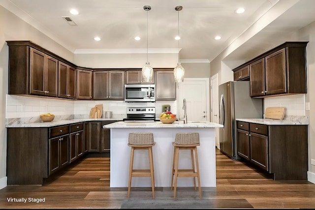 kitchen with dark brown cabinetry, visible vents, dark wood-style floors, and appliances with stainless steel finishes