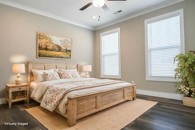 bedroom with dark wood-style floors, crown molding, visible vents, ceiling fan, and baseboards