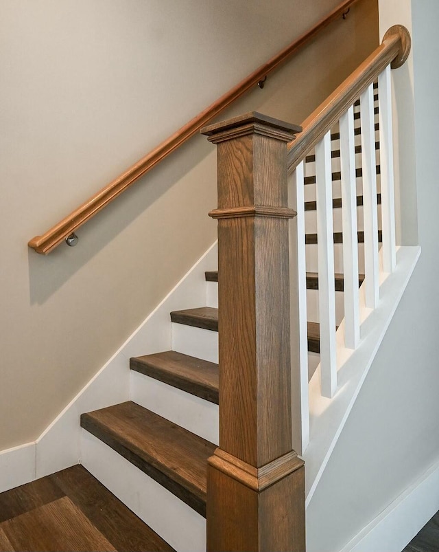 stairway with wood finished floors