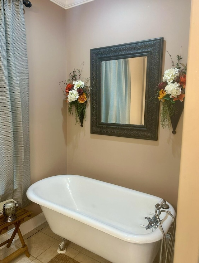 bathroom with tile patterned flooring, a tub to relax in, and crown molding