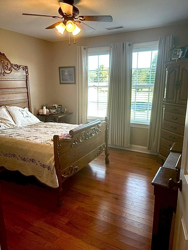 bedroom with hardwood / wood-style flooring and ceiling fan