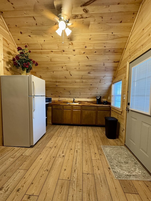 additional living space featuring wood ceiling, lofted ceiling, wooden walls, and light hardwood / wood-style floors