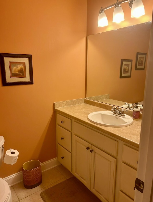 bathroom featuring vanity, tile patterned floors, and toilet