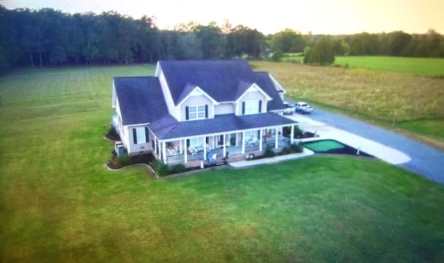 exterior space featuring a lawn and a porch